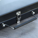 Black grill with a handle on a wooden surface
