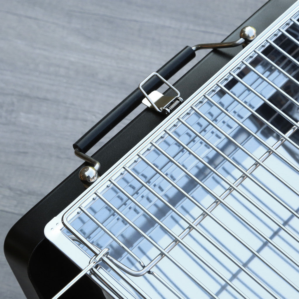 Close-up of a grill with a metal grate on a gray surface