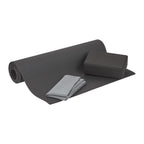 Gray yoga mat, block, and towel on a white background