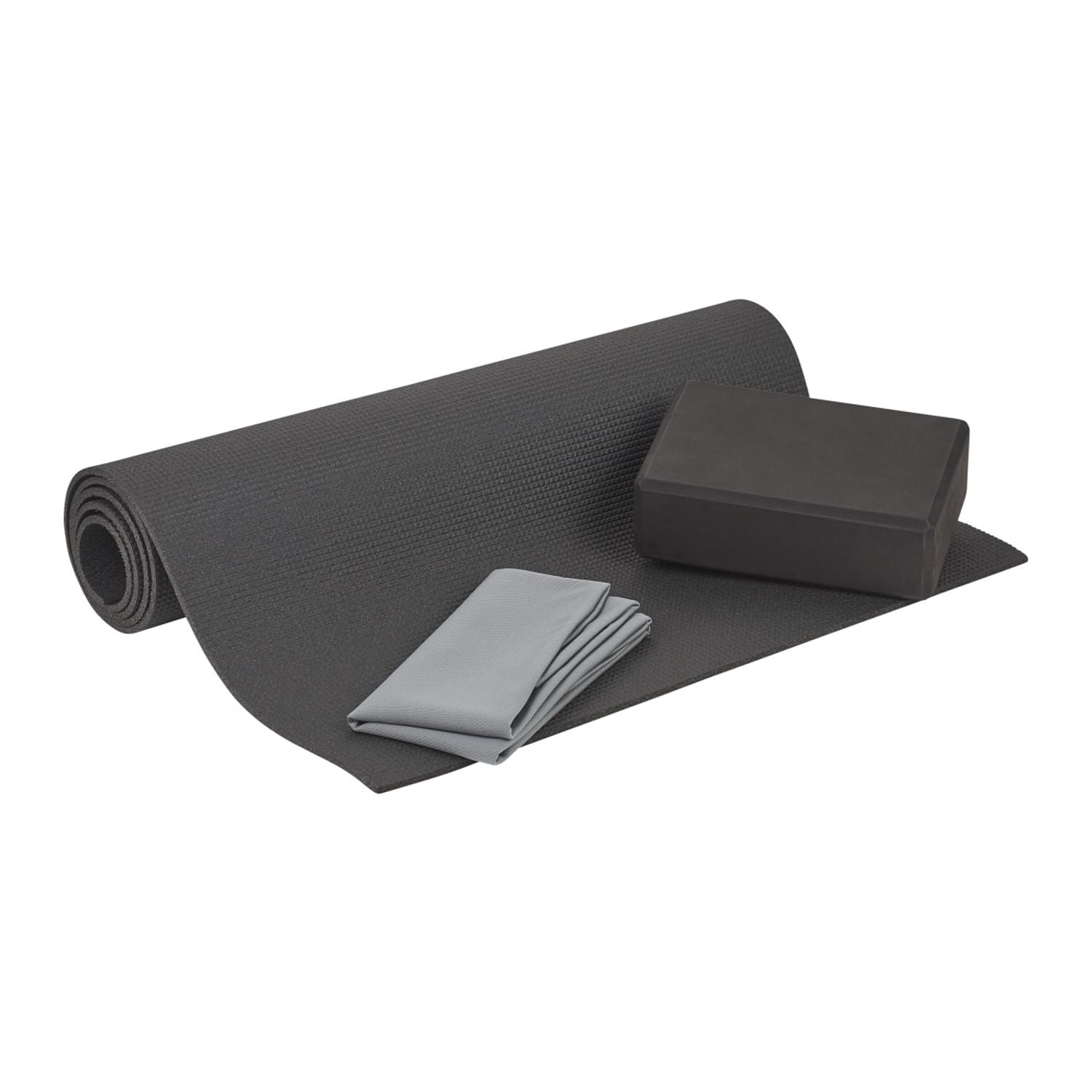Gray yoga mat, block, and towel on a white background