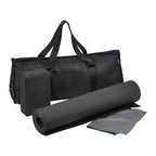 Black yoga mat, block, and towel with carrying bag on a white background