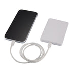 a smartphone shown connected to MI Power 5000 mAh MagClick™ 15W Wireless Power Bank