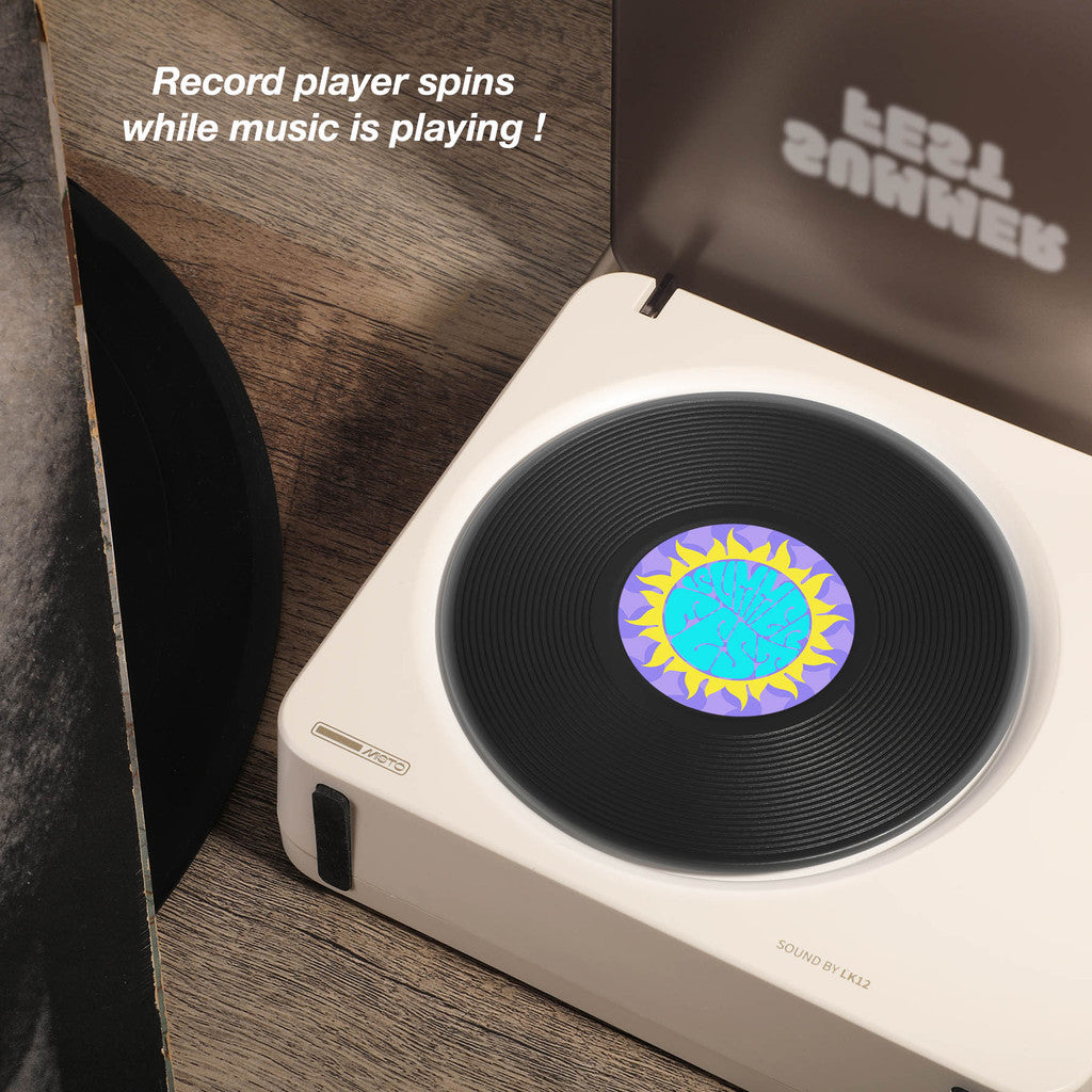 Record player with a vinyl record on a wooden surface, featuring text 'Record player spins while music is playing!'.