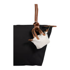 Natural Mini Fontaine Tote Charm shown attached to a large tote bag