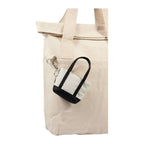 Black Mini Tote Bag Charm shown attached to a tote bag 