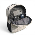 Open backpack showing compartments with electronic devices on a white background