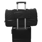 Node Shoe Compartment Duffel shown atop a luggage bag