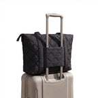 Venus 17" Laptop Tote shown on top of a suitcase
