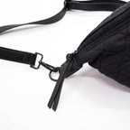 Black quilted fanny pack with a strap on a white background