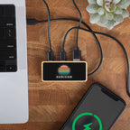 a custom logo USB hub on a wooden surface with a smartphone and laptop.