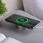 Wireless phone charger on a table with a smartphone displaying charging status