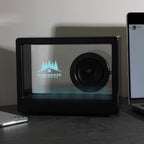 Crystal Clear Wireless Speaker shown with a laser engraved logo and blue led lights turned on