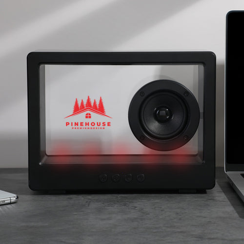 Crystal Clear Wireless Speaker shown with a laser engraved logo and red led lights turned on