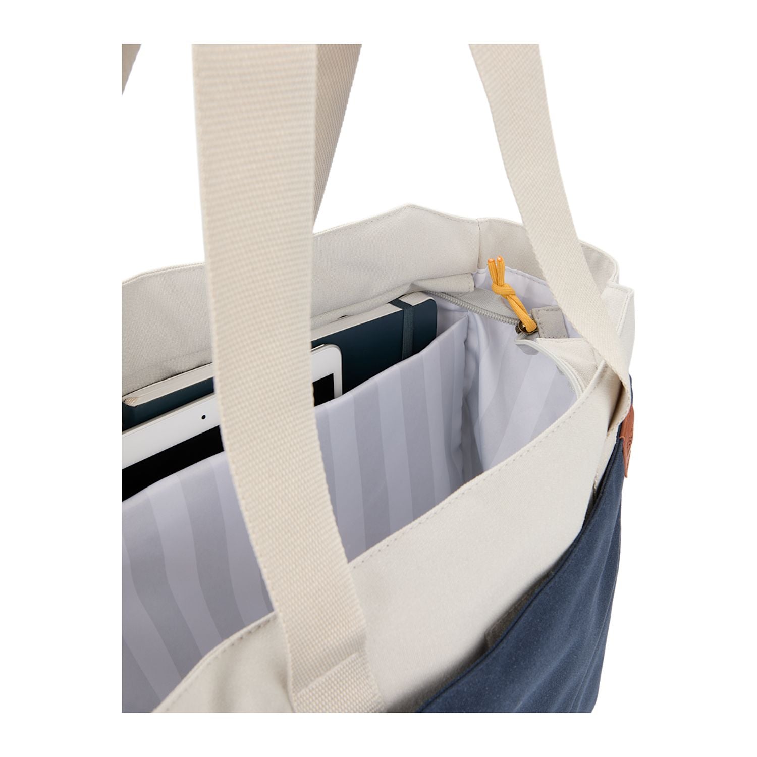Close-up of a tote bag with a laptop compartment on a white background