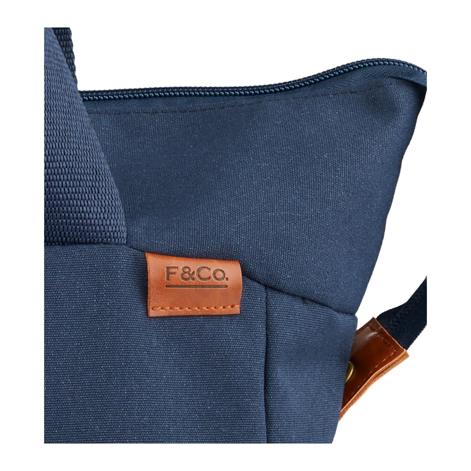 Blue bag with a brown leather tag featuring 'F&Co.' on a white background