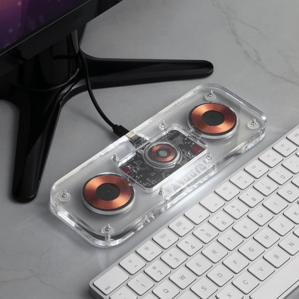 Custom Wireless Charger next to a keyboard and monitor.