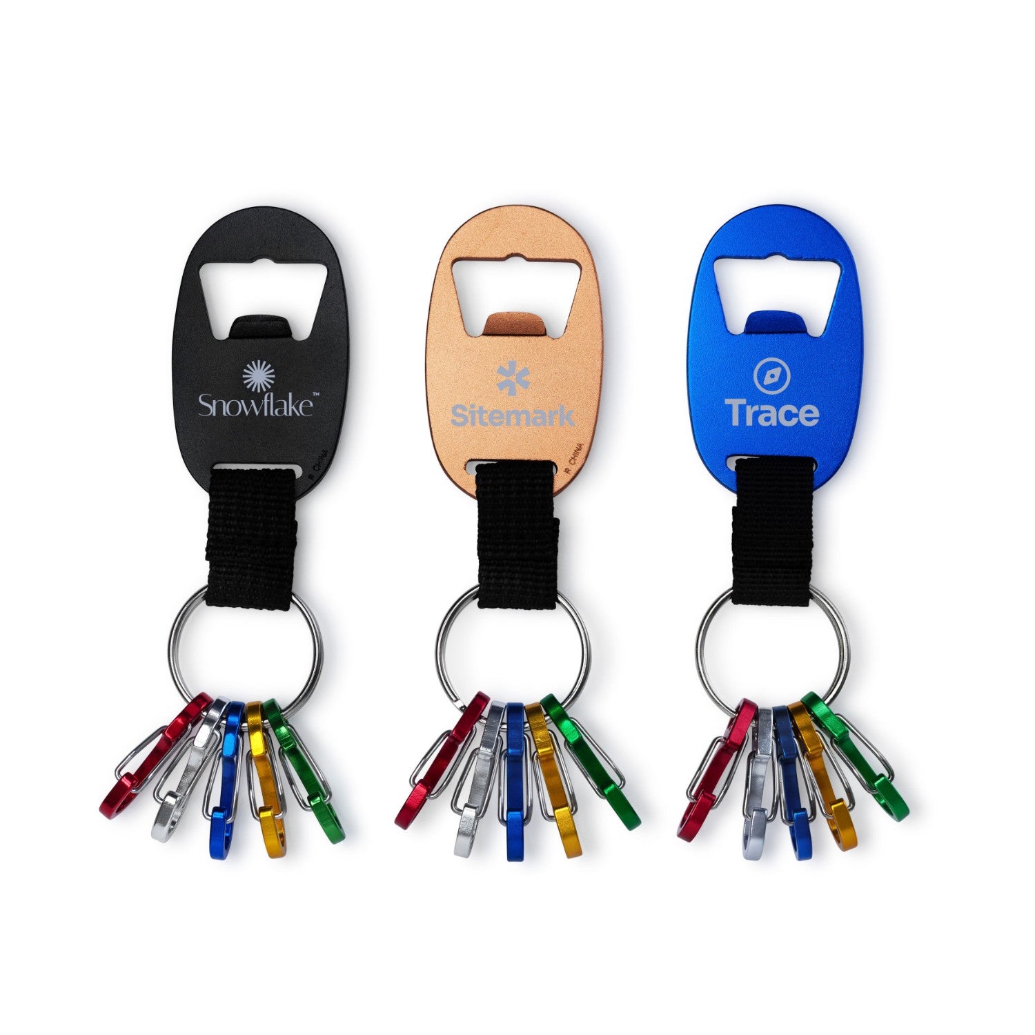 Three bottle openers with keychains on a white background
