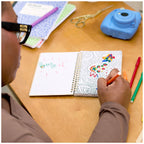 Mix Doodle Notebook with Markers in Use by a person coloring in it