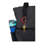 Black tote bag with a key and colorful mug attached, on a white background