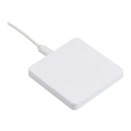 A white square wireless charging pad with a cable connected to one side, shown on a plain white background.