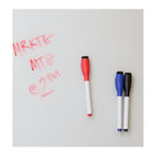 Three markers with red, blue, and black caps on a whiteboard with red writing.