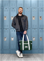Man holding a green Varsity Club Tote in front of blue lockers