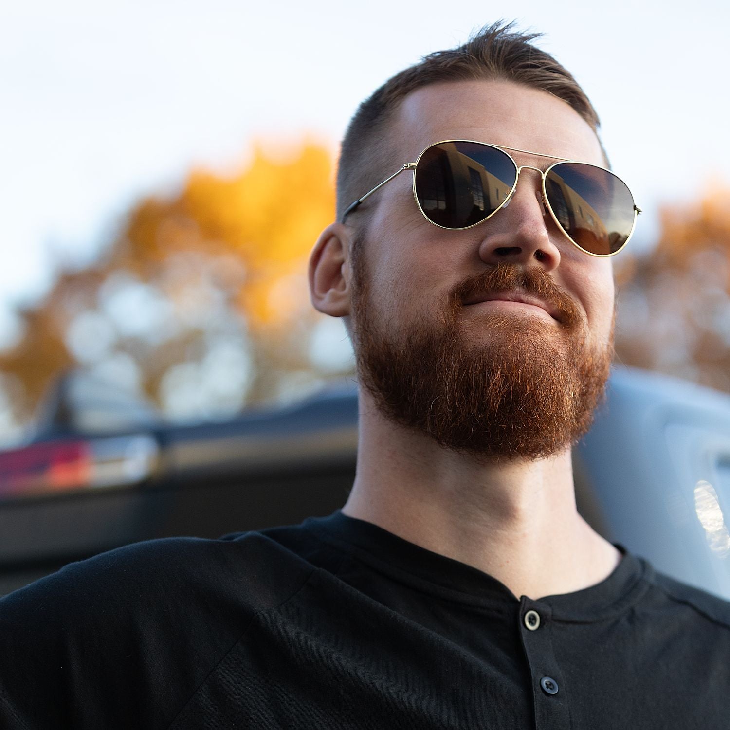 Gold Stunkel Recycled Aviator Sunglasses shown on a person's face