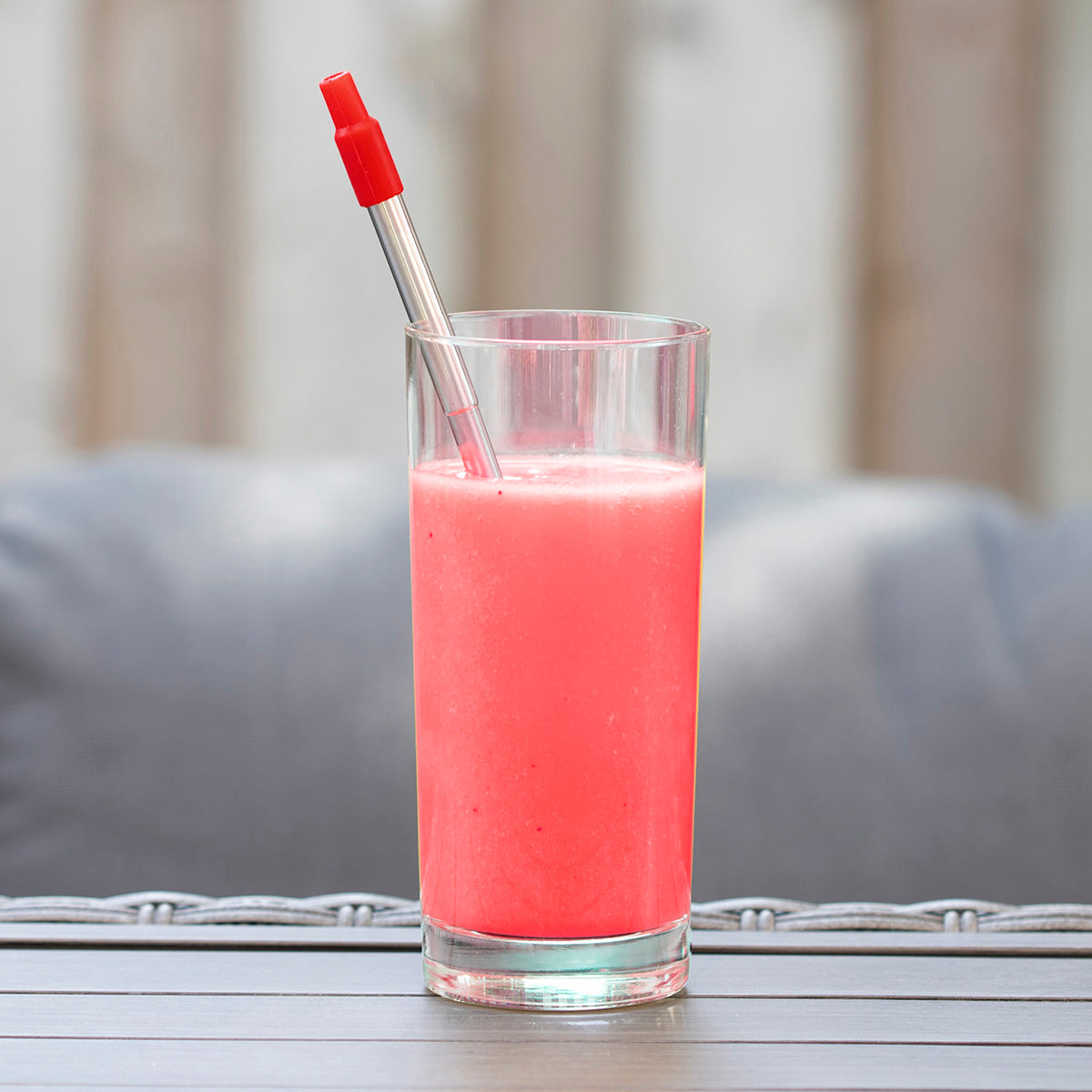 Red 8" Reusable Stainless Steel Straw shown inside of a beverage