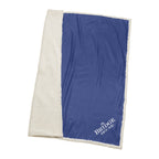 Blue and white blanket with 'The Bridge House' logo on a white background